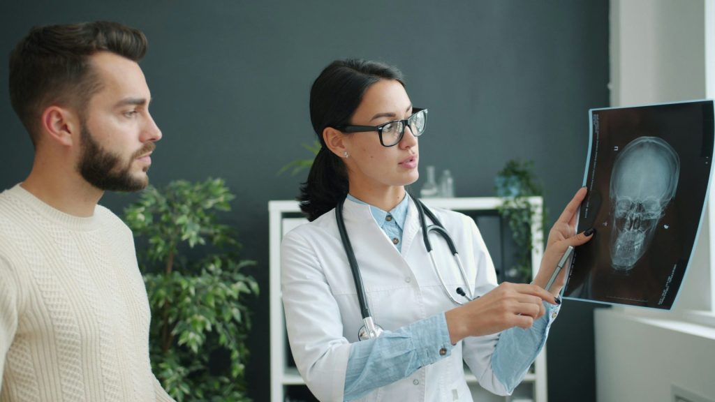 Doctor explains skull x-ray to patient